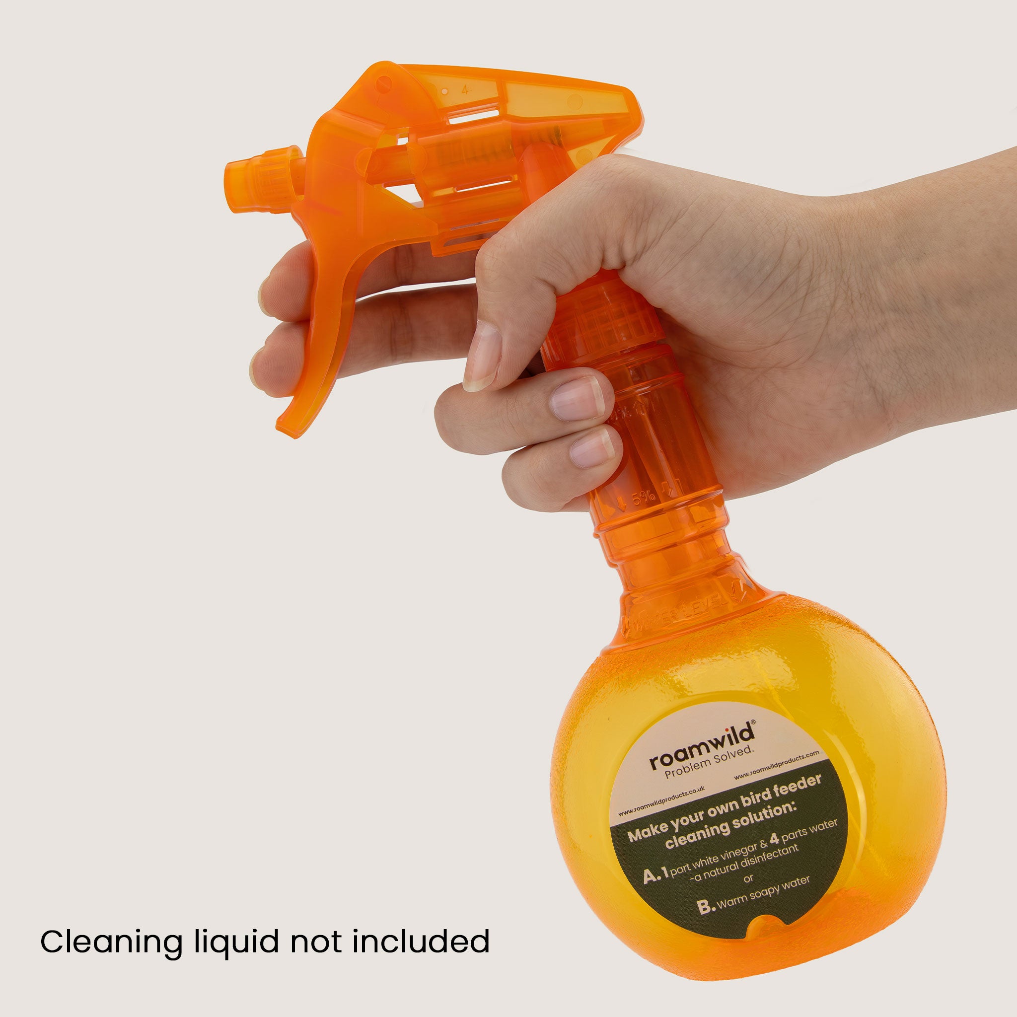 Spraying a garden bird feeder clean with the Roamwild feeder cleaning spray bottle