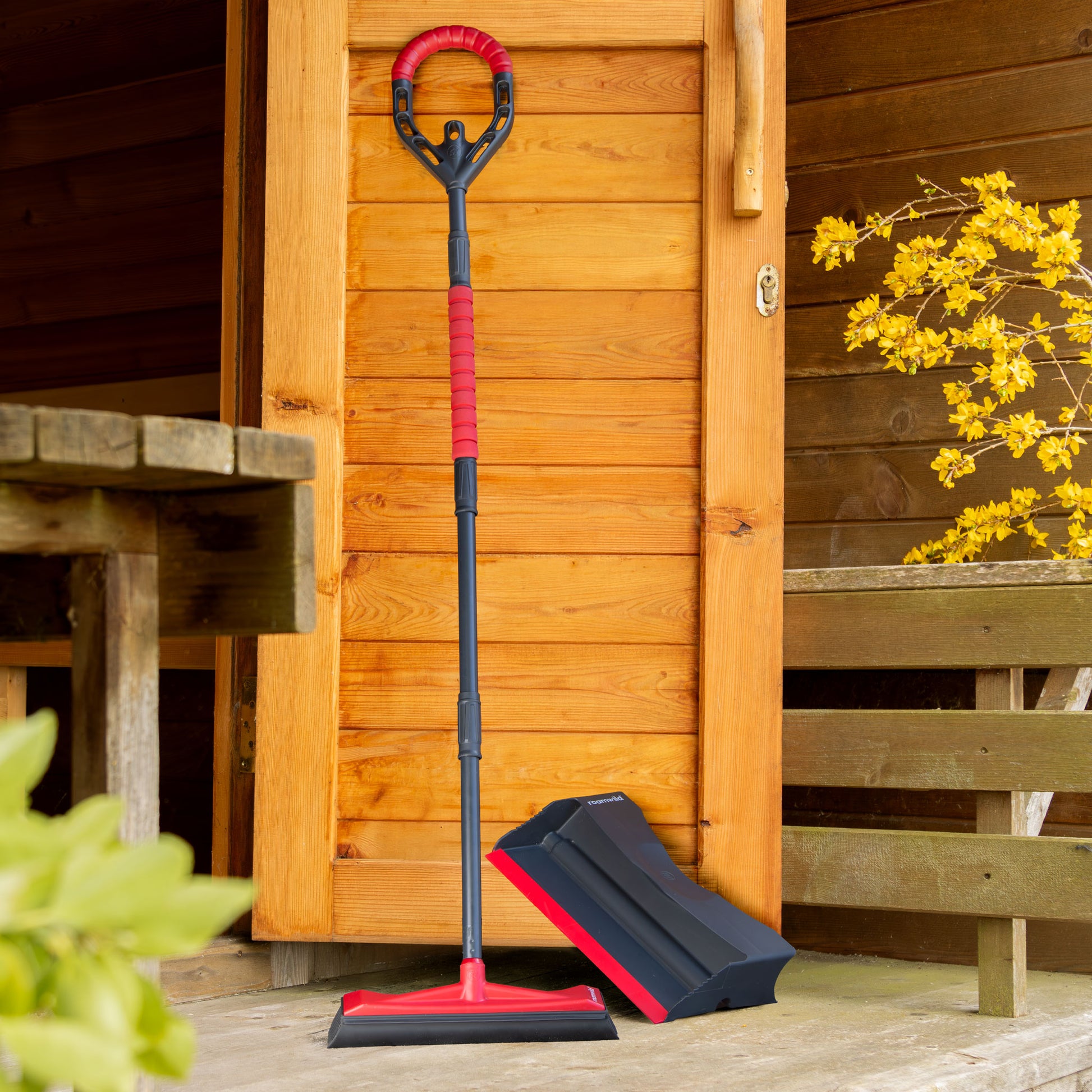 Roamwild garden broom in use clearing a garden path